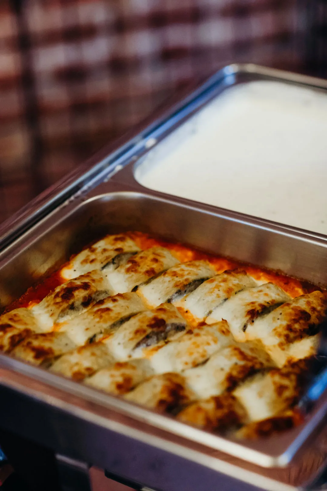 Creamy baked casserole in a buffet chafing dish
