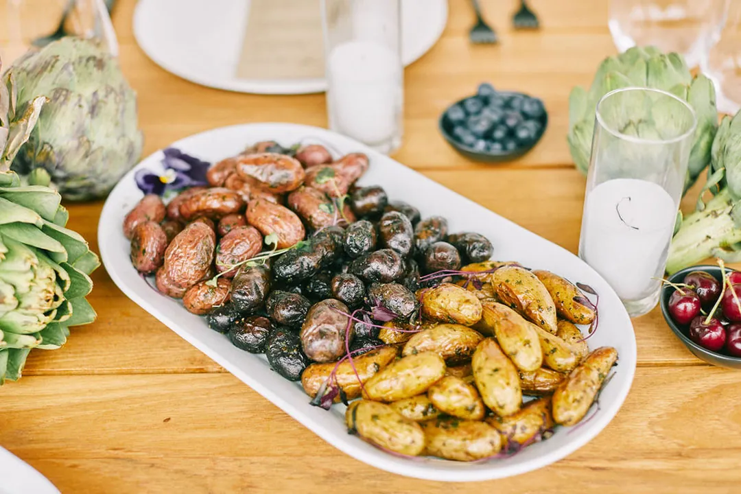 Platter of roasted red, purple, and golden fingerling potatoes