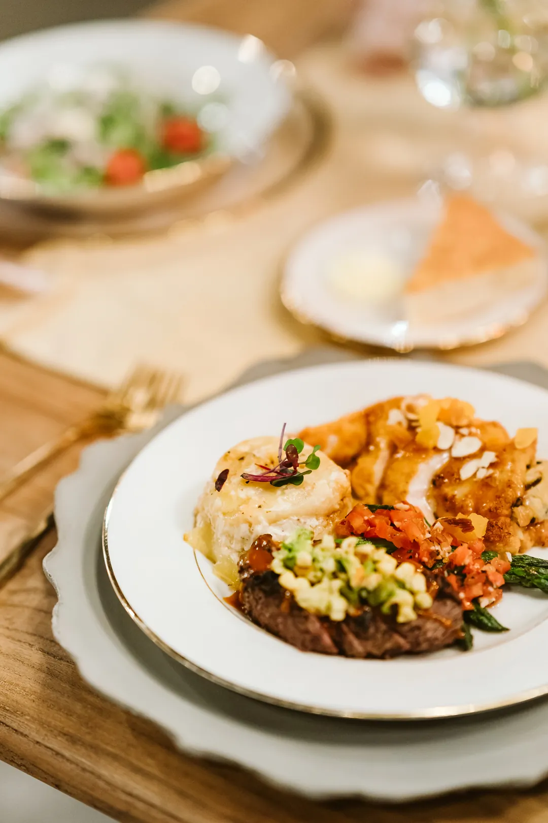Plated holiday entrée with sliced meat, vegetables, and potatoes