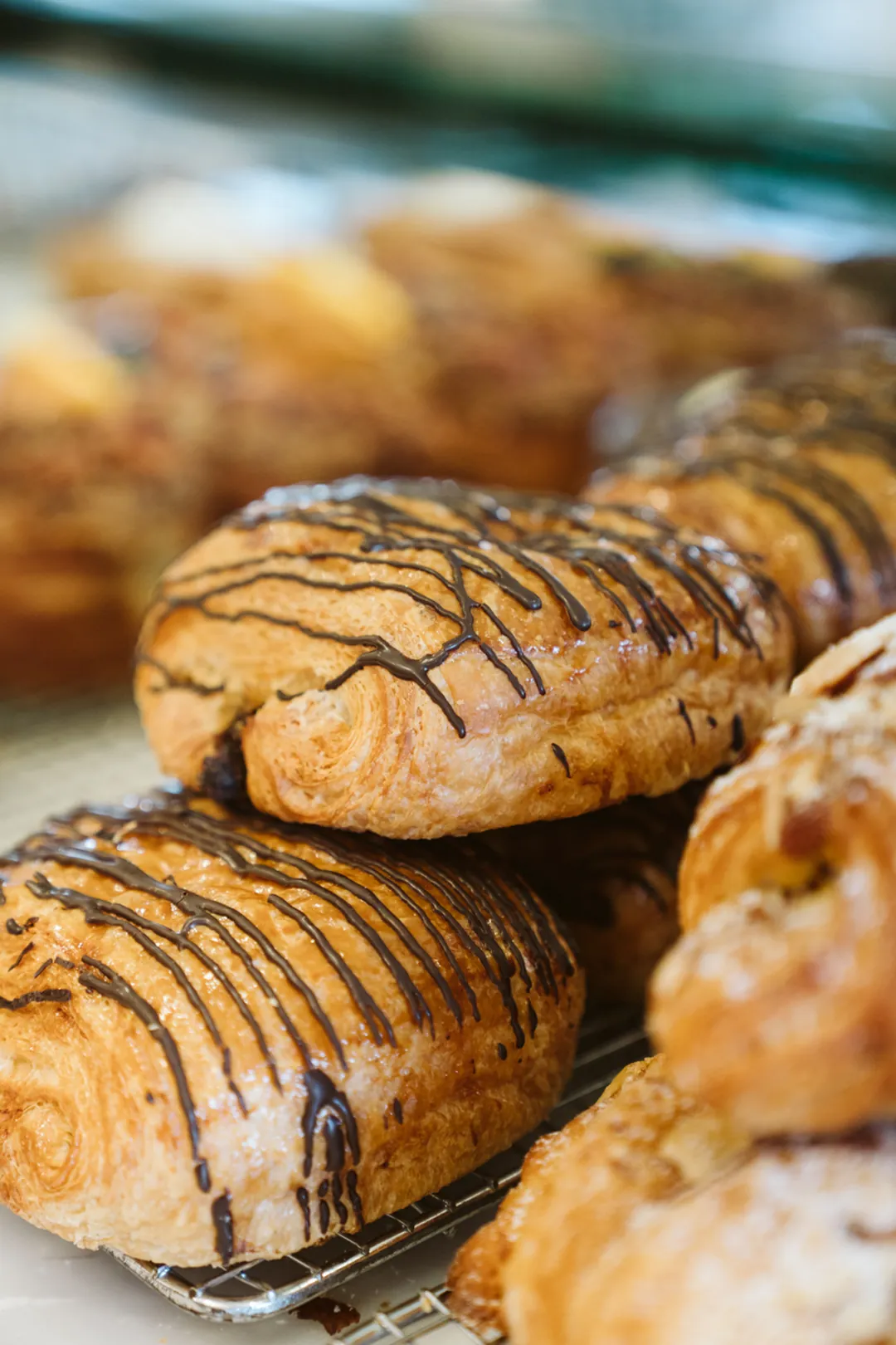 Chocolate-drizzled croissants in the pastry case