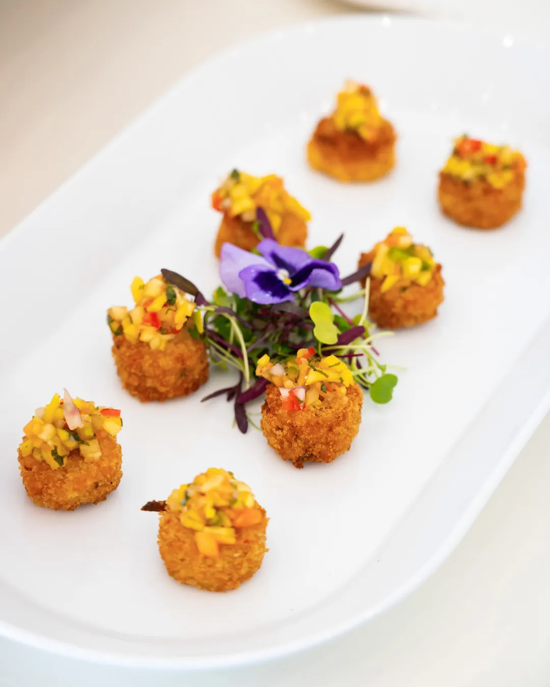 Crispy appetizer bites topped with diced vegetables