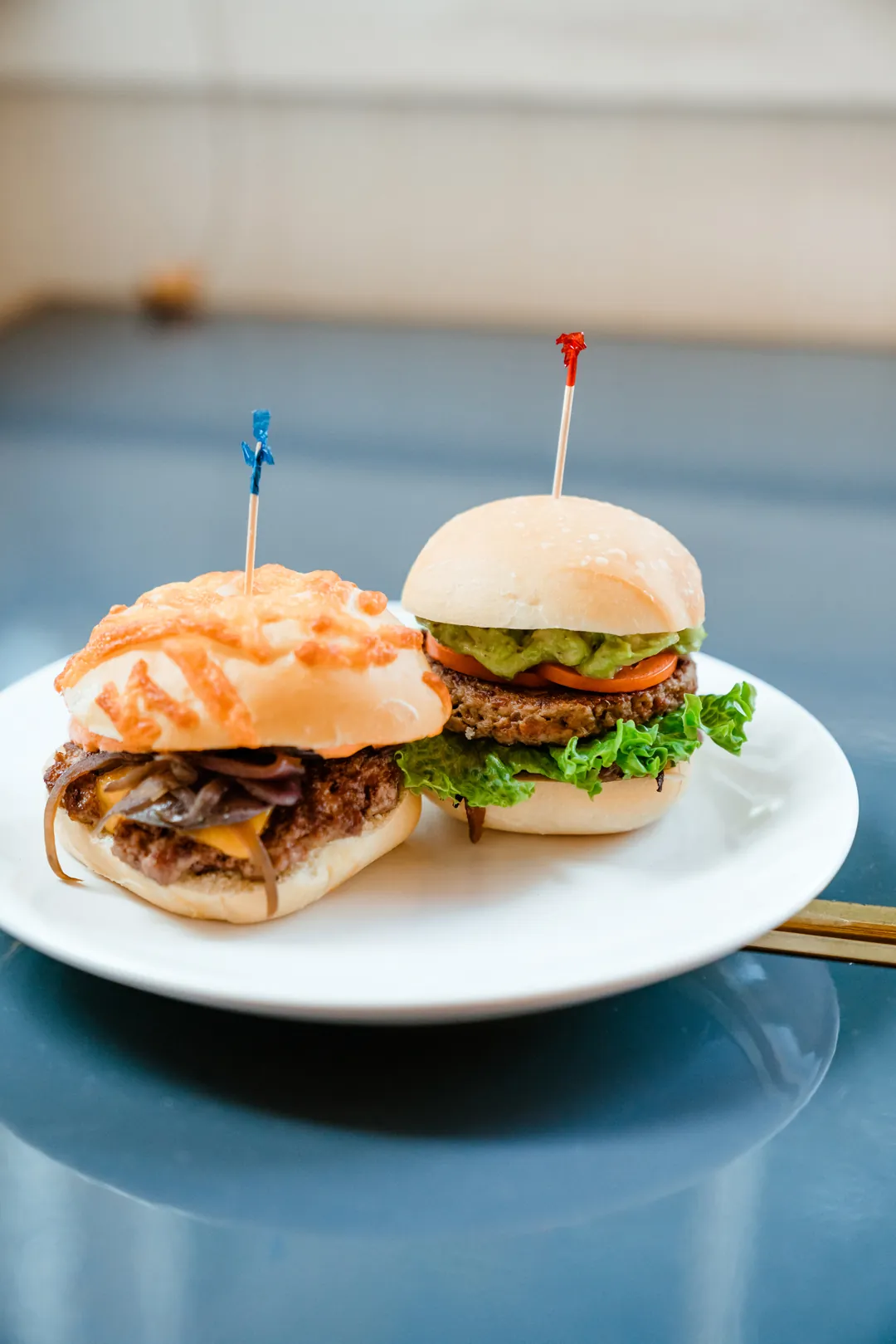 Carnitas slider and Impossible burger on a white plate