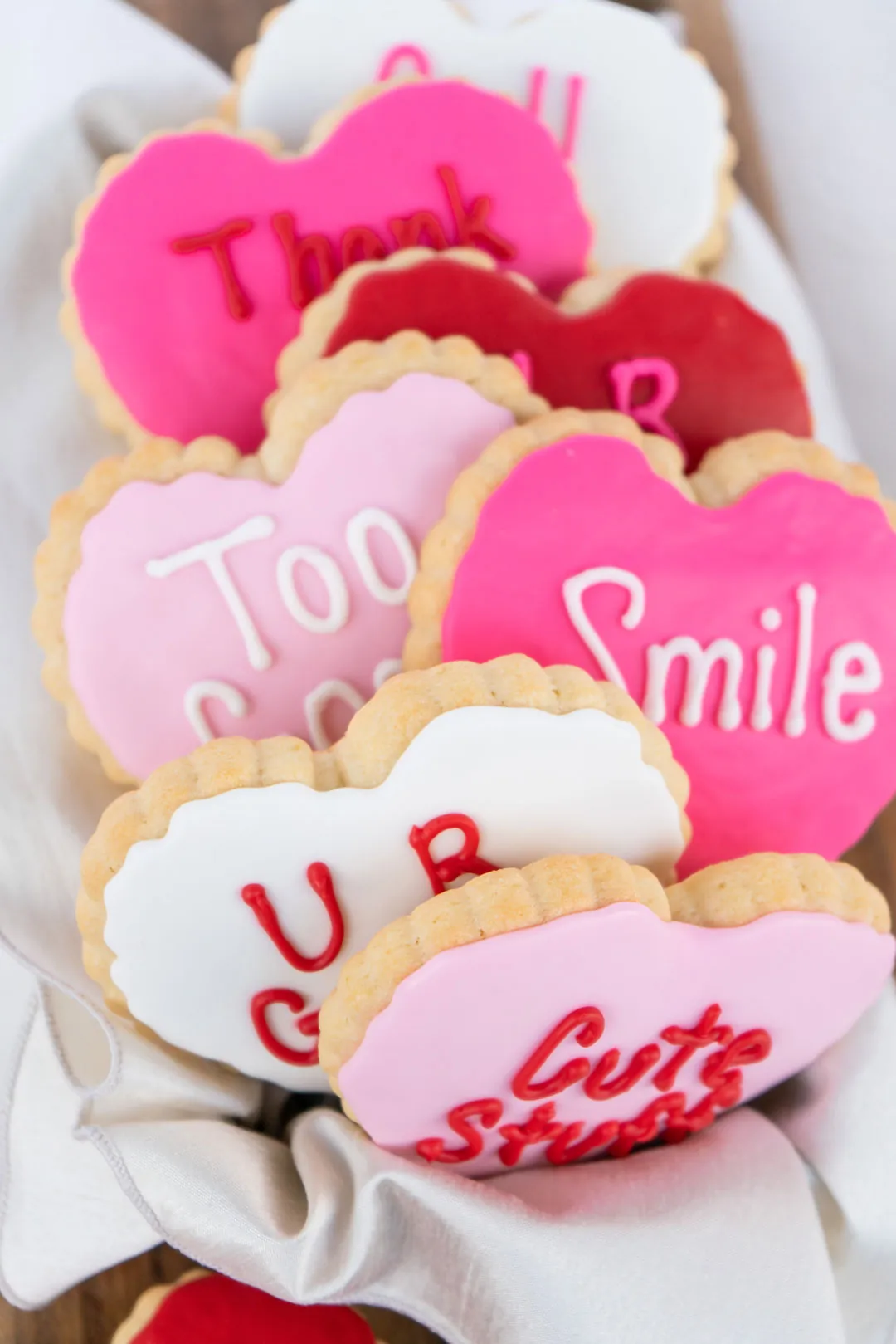 Assortment of pink, red, and white conversation heart cookies