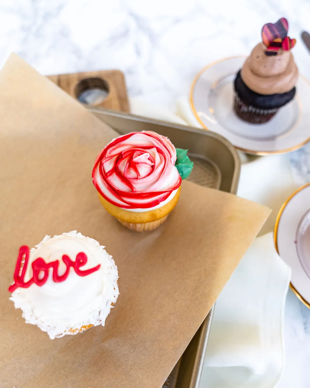 Valentine cupcakes with rose, heart, and chocolate decorations