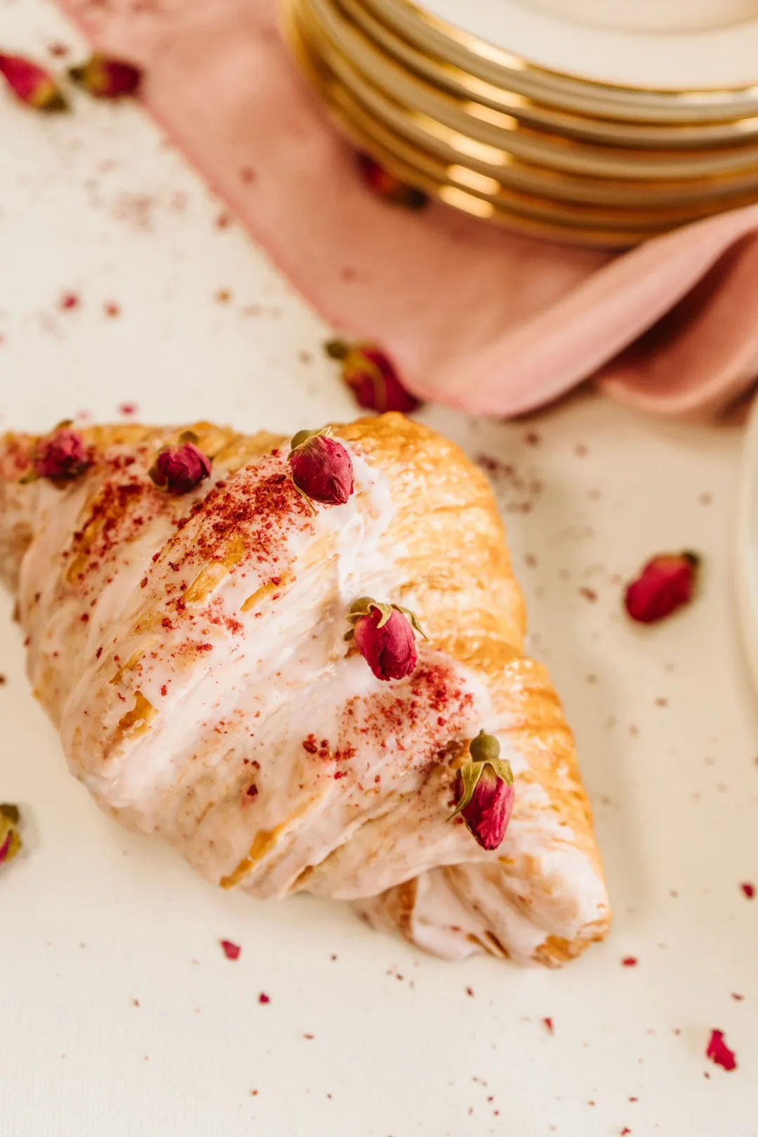 Raspberry rose croissant with rose glaze and dried rose buds