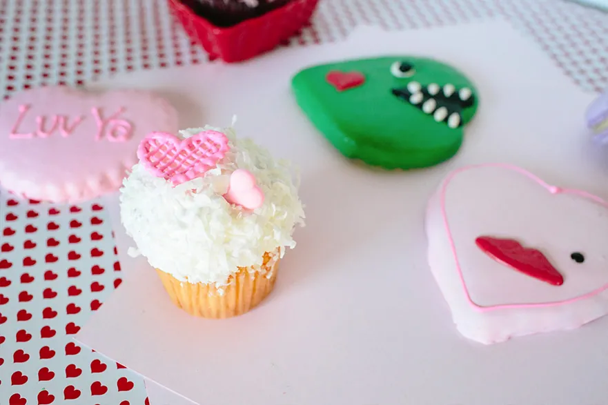 Coconut cupcake beside Monster Heart and Heart Lips sugar cookies