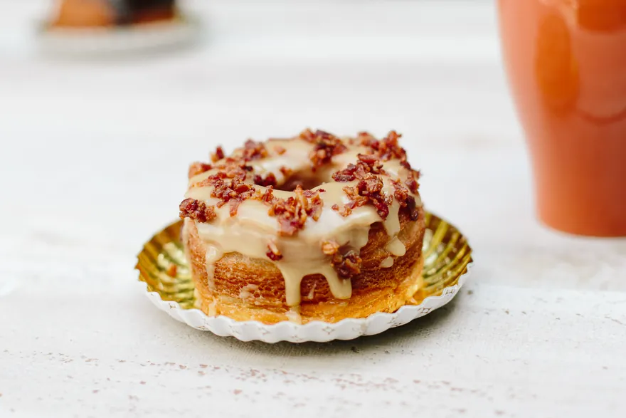 Iced pecan pastry on a gold paper plate