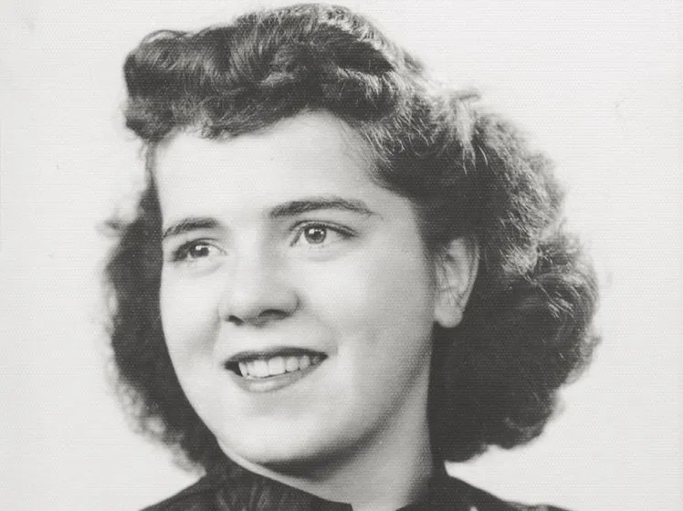Black-and-white portrait of a smiling young woman