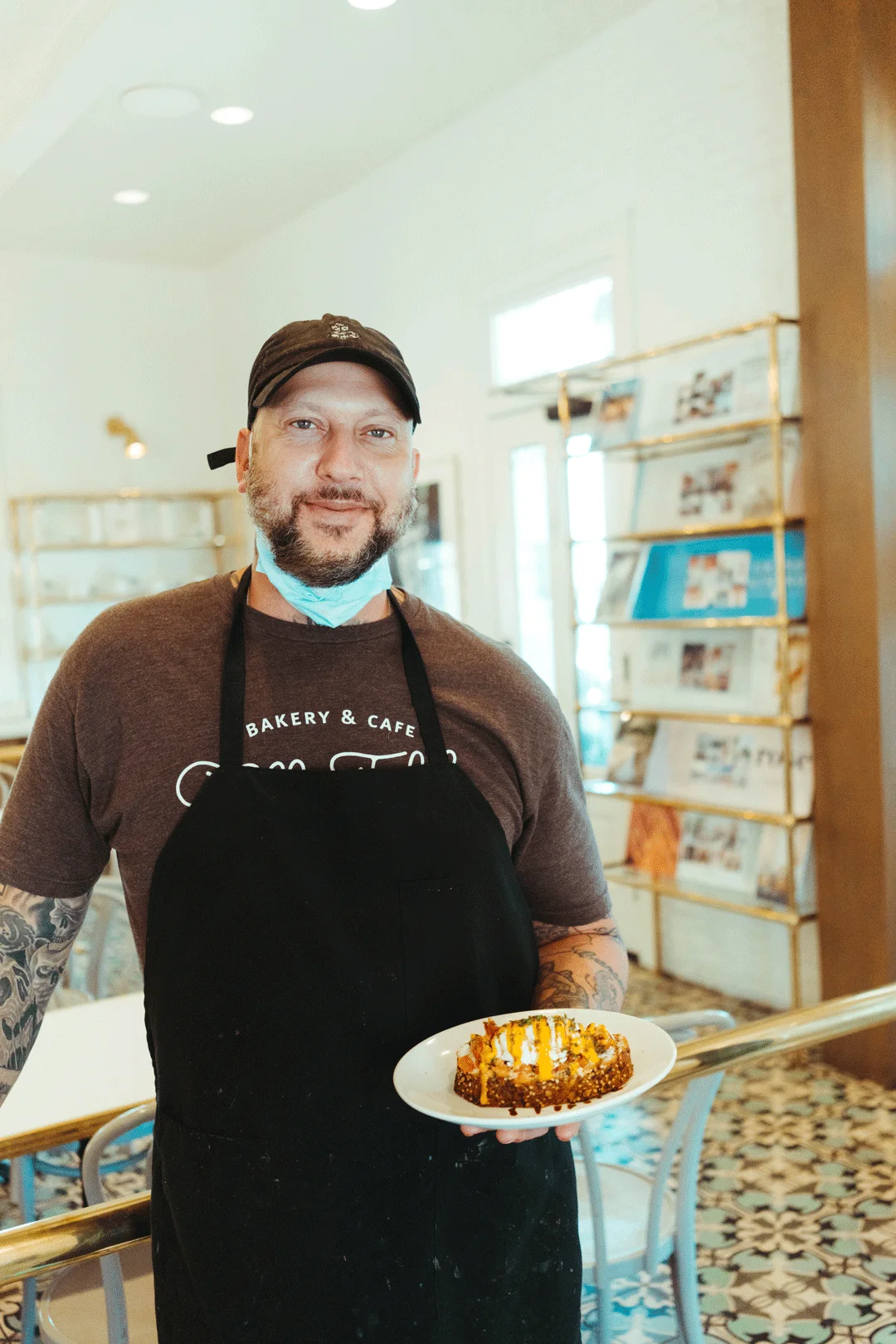 Chef Ken holding a prepared breakfast plate inside Ellie’s Table
