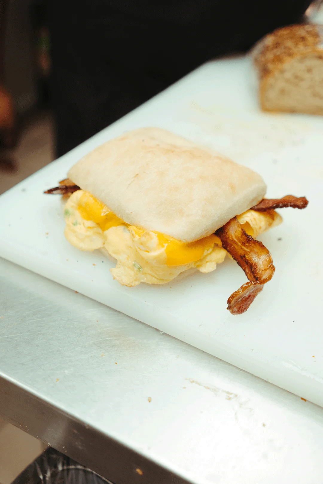 Breakfast sandwich with egg, cheese, and bacon on ciabatta