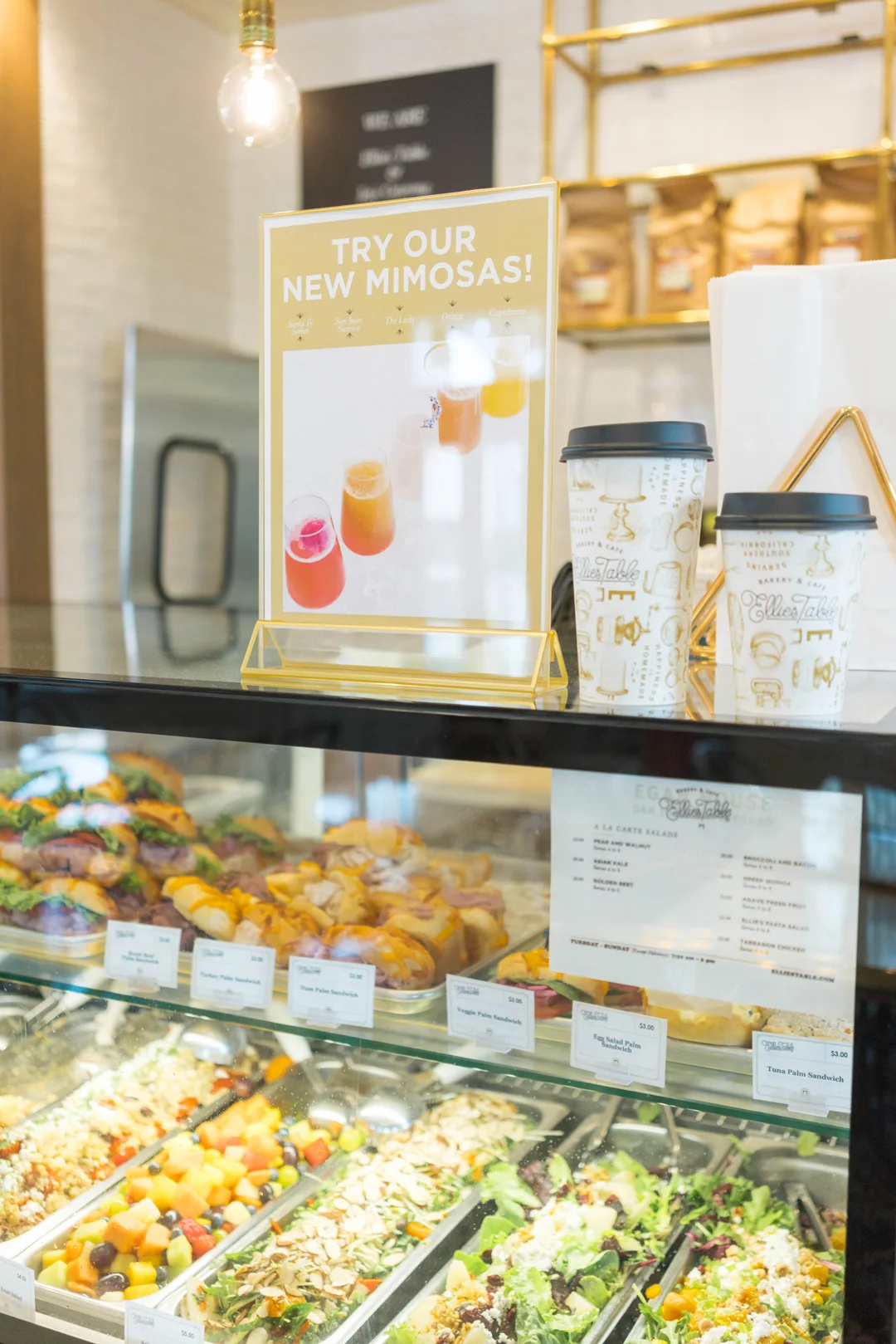 Refrigerated café case filled with prepared salads and pastries