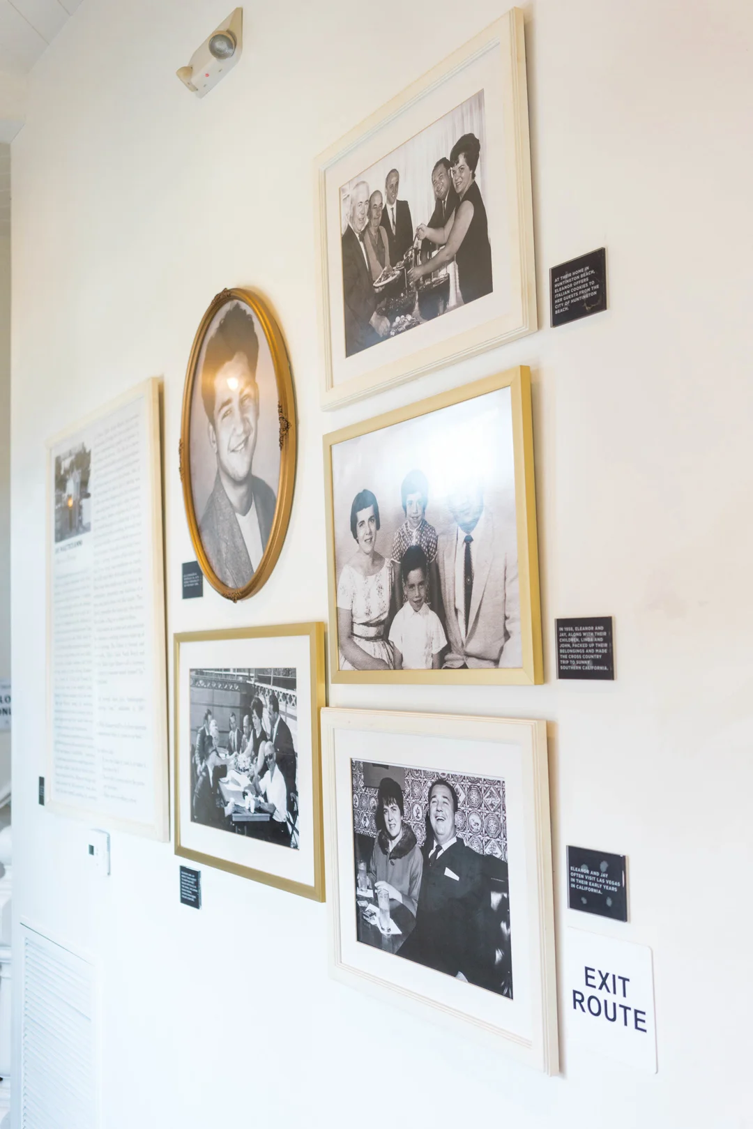 Hallway wall displaying framed historical family photographs