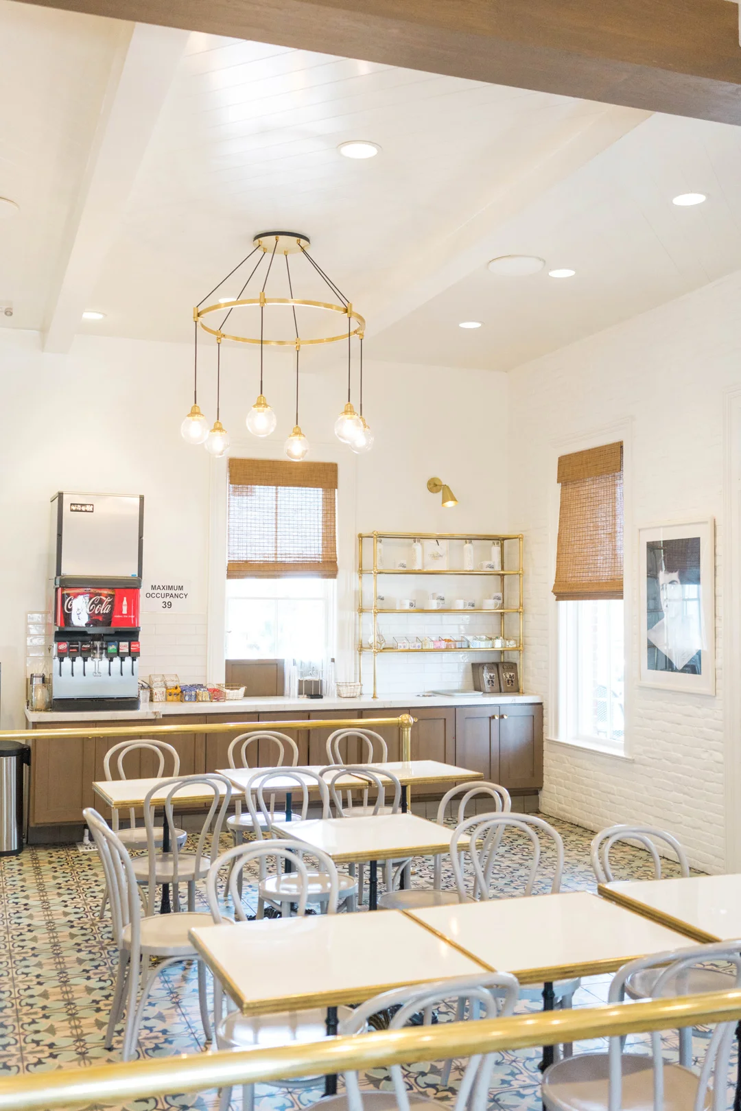 Indoor seating area with metal chairs and a beverage station