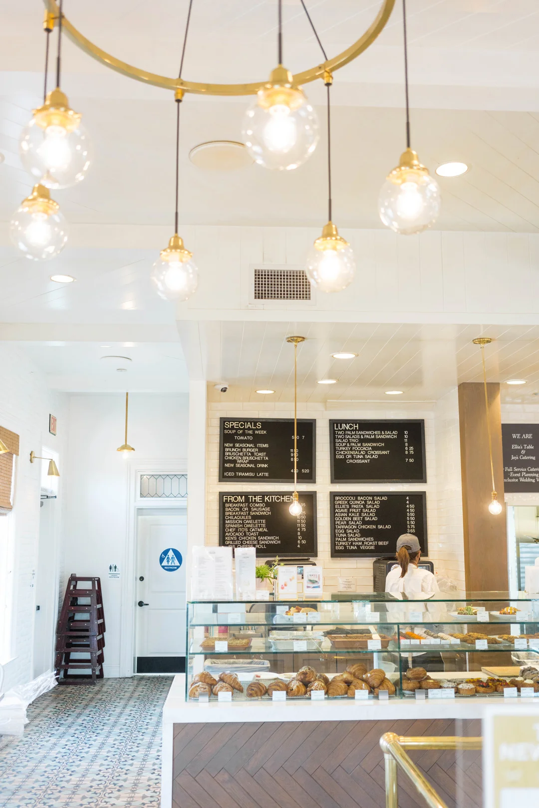 Ellie's Table café counter beneath hanging globe lights