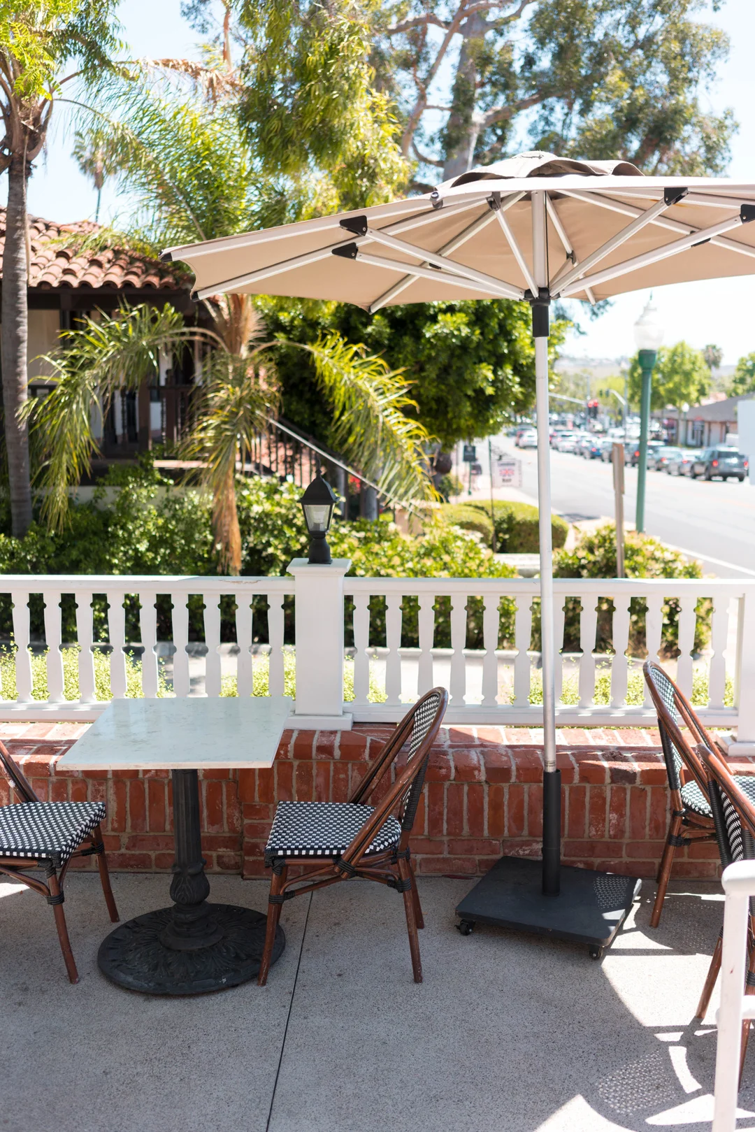 Shaded patio table beneath a large umbrella
