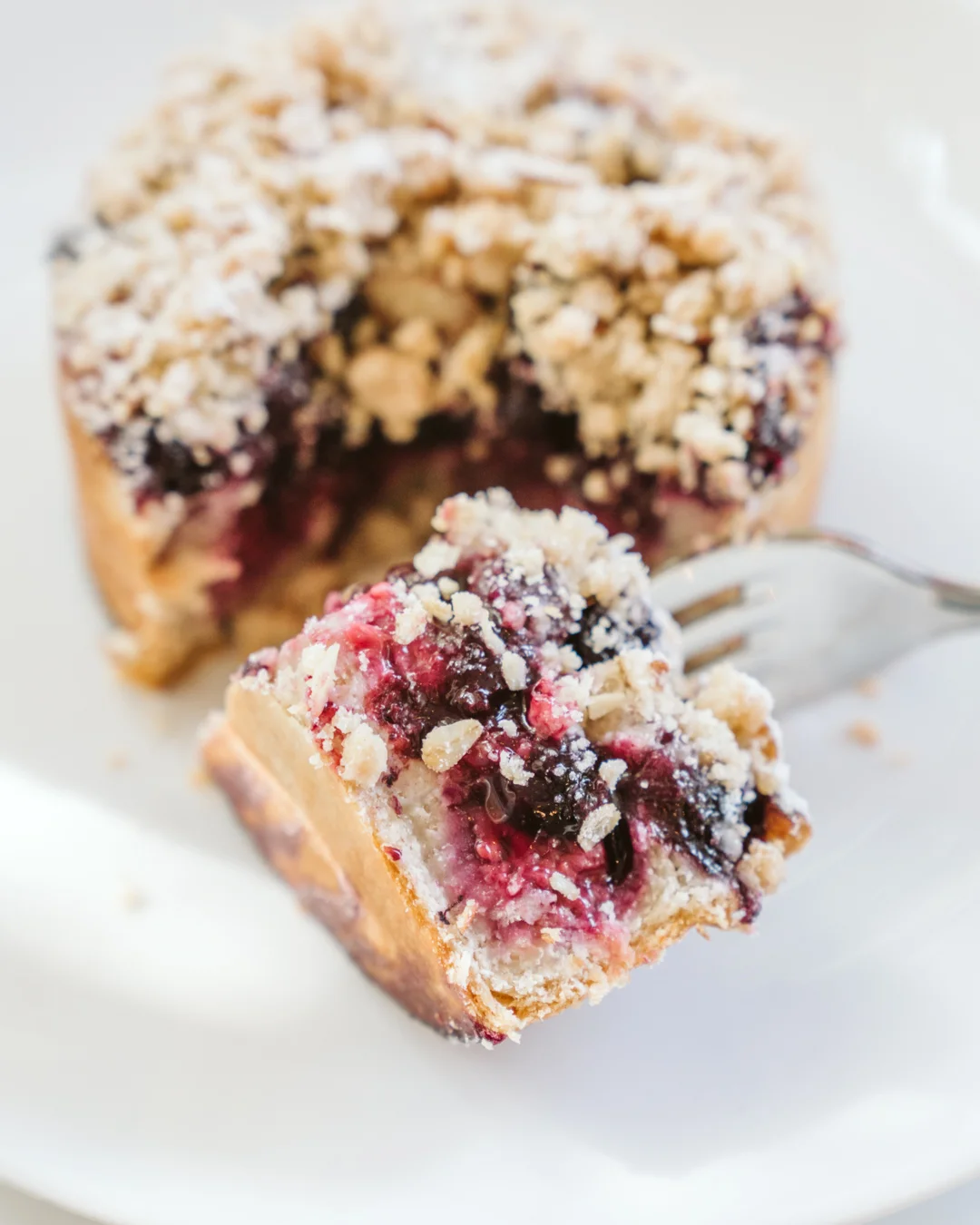 Berry-filled pastry cut open on a fork