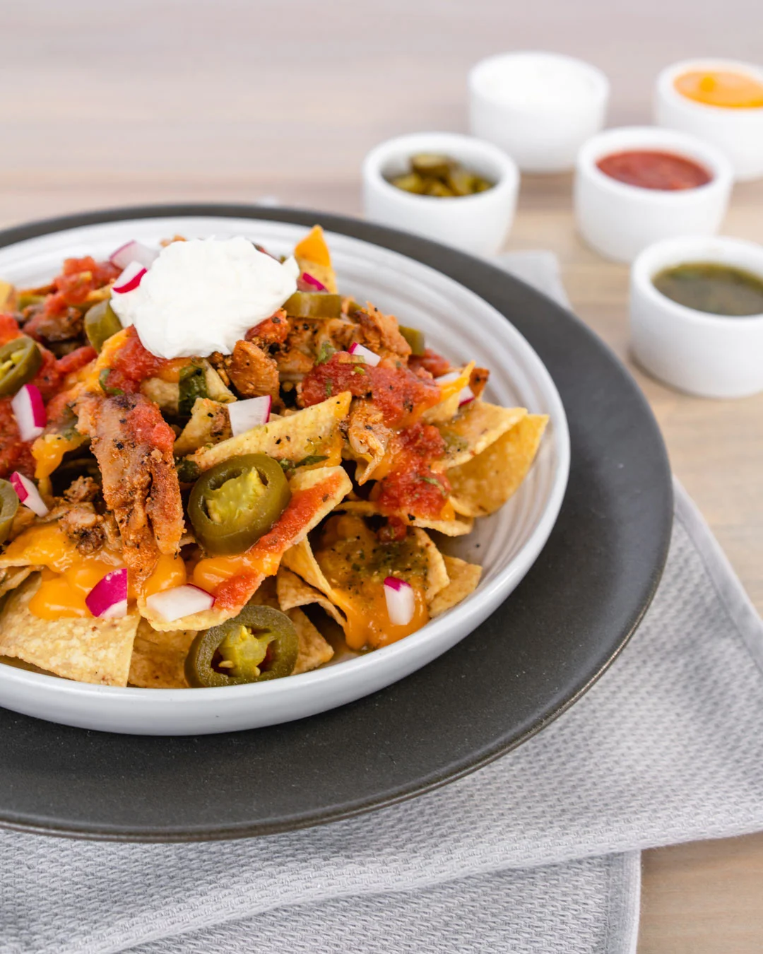 Chicken nachos with cheese, salsa, jalapeños, onions and sour cream