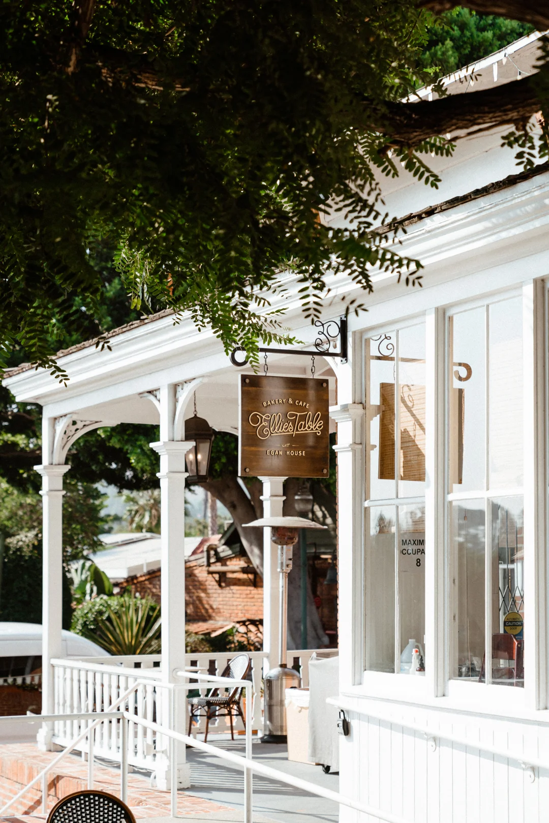 Ellie’s Table at the Egan House with its porch and hanging café sign