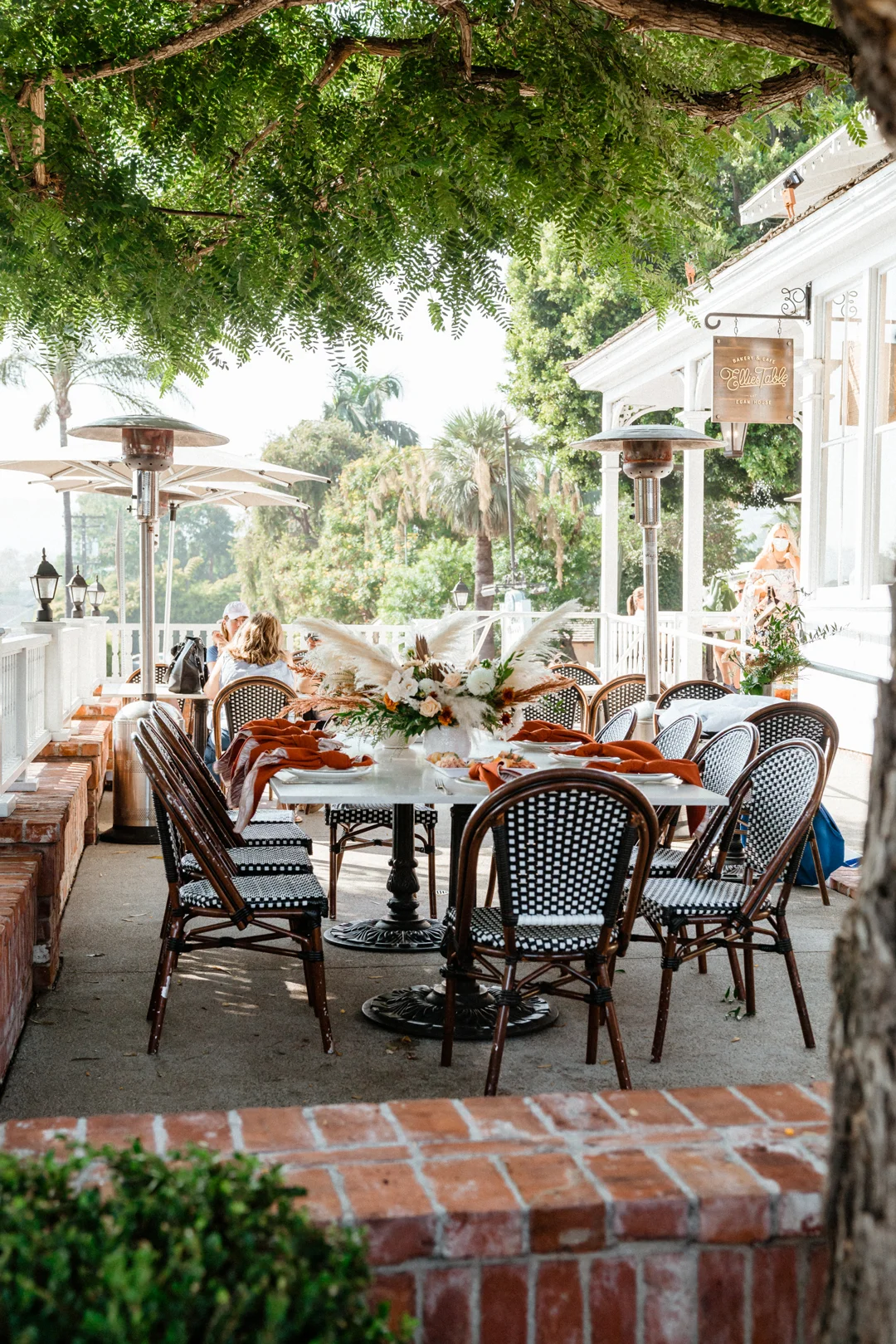 Outdoor celebration table set beneath trees at the Egan House