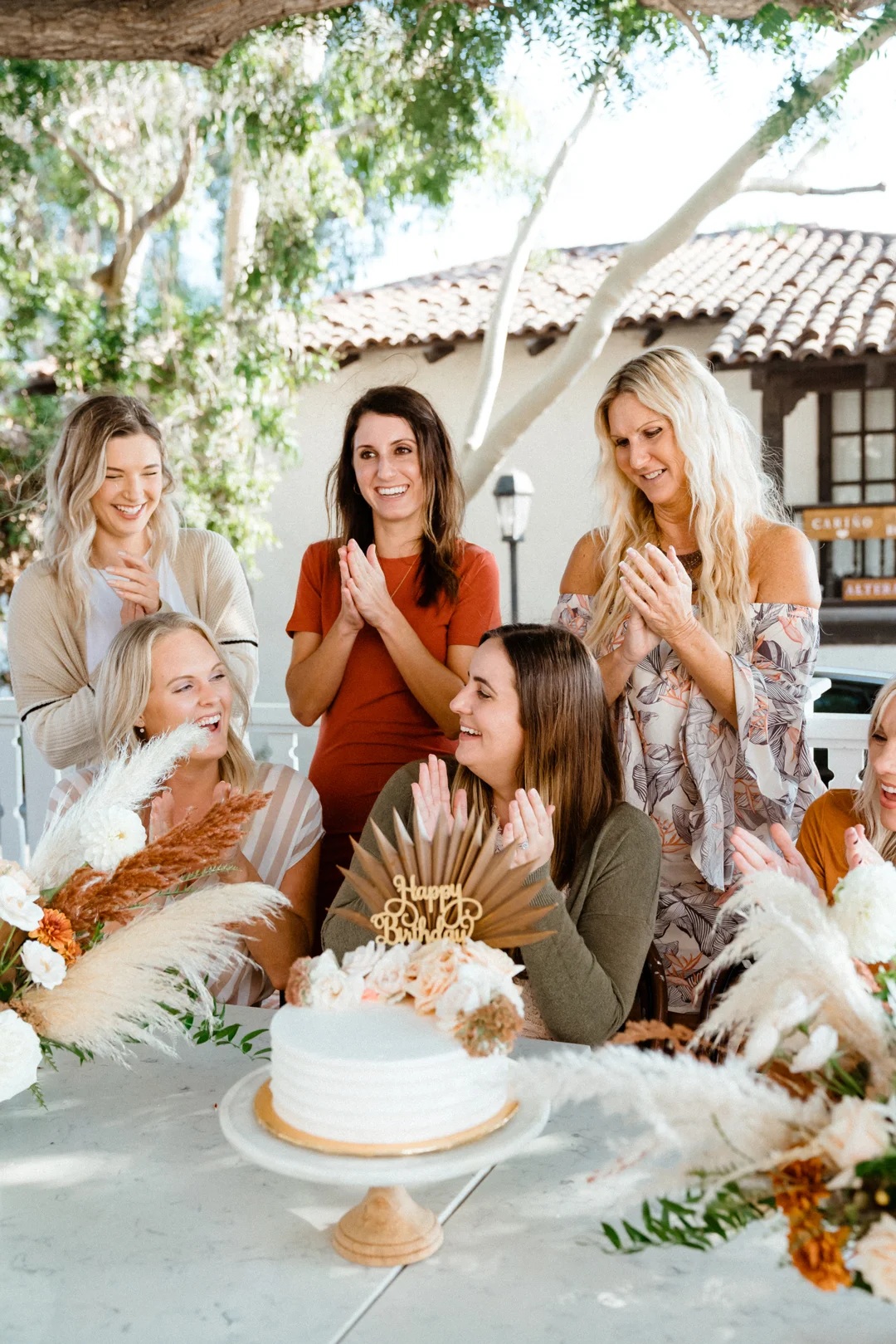 Friends celebrating together around the cake