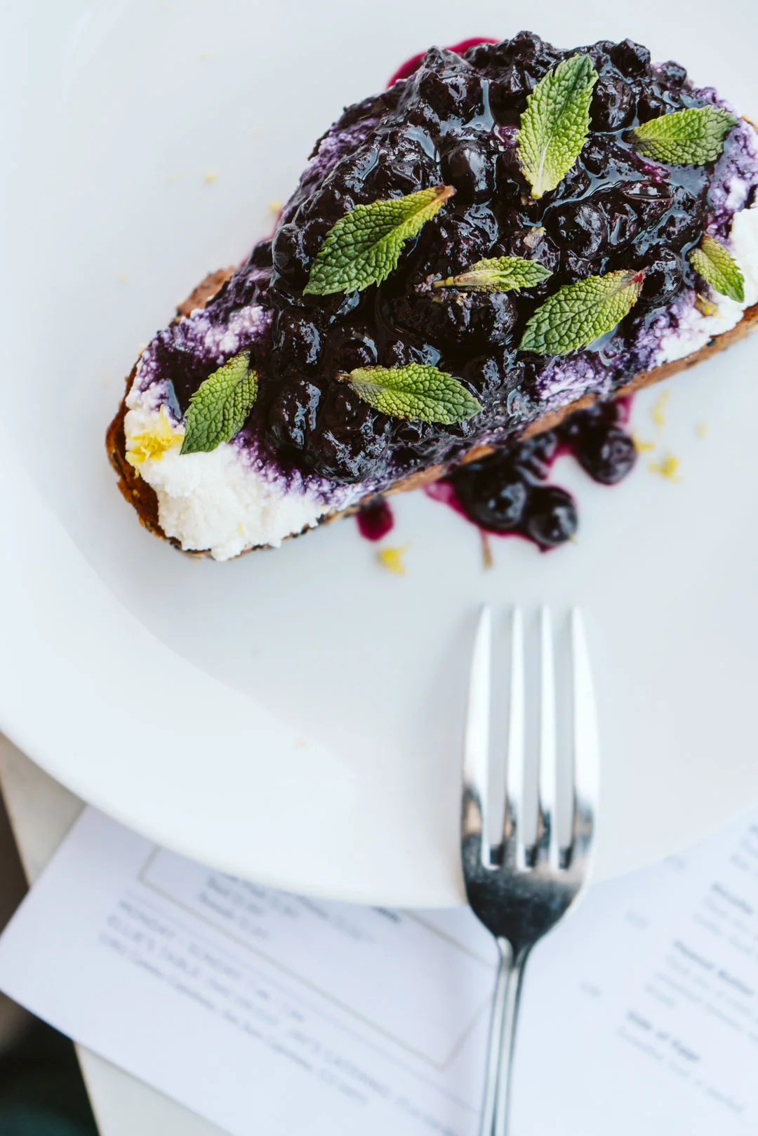 Blueberry compote and mint over ricotta toast