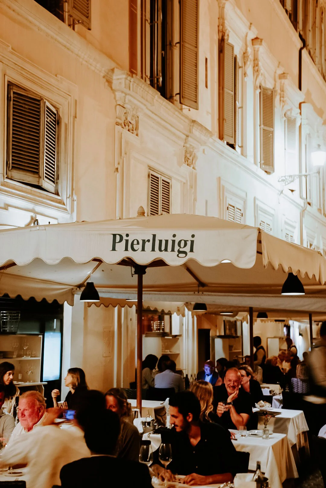 Guests dining outside Pierluigi restaurant in Rome