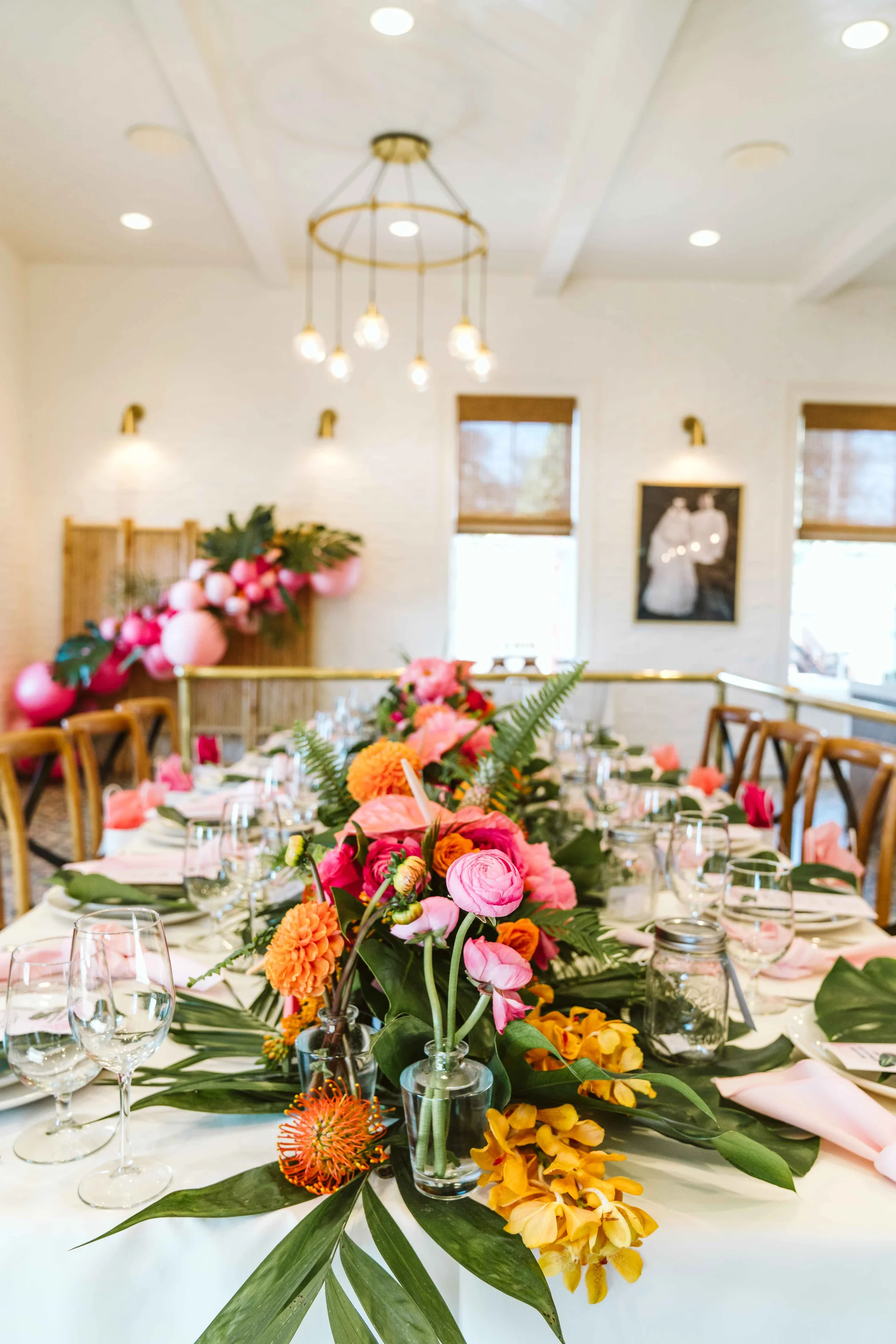 Orange and pink floral centerpiece on the dinner table