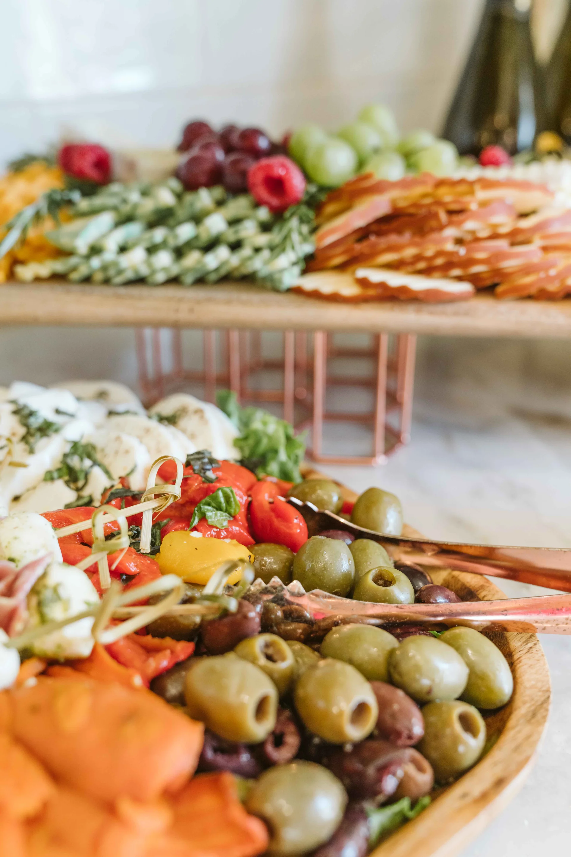 Antipasto spread with olives, cheese, cured meat, fruit, and vegetables