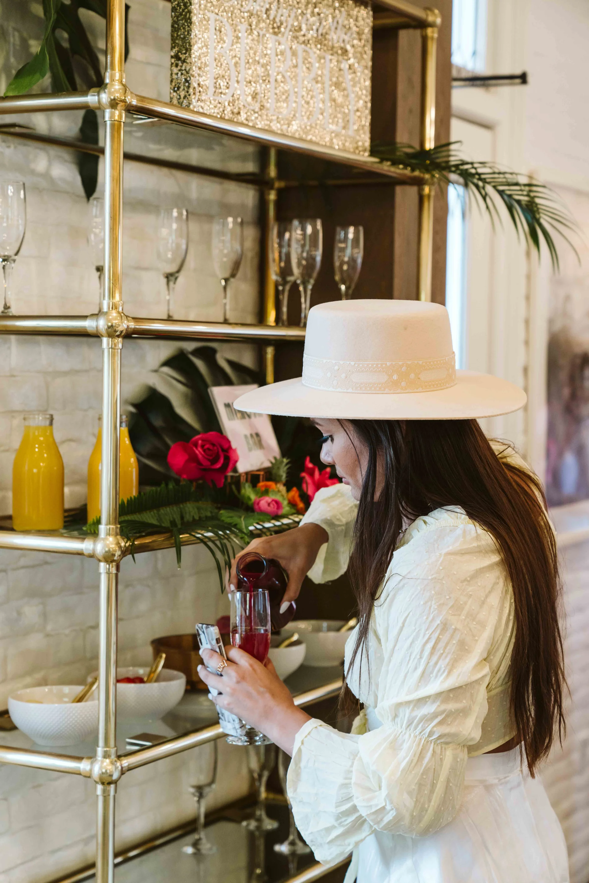 Guest pouring red juice at the mimosa bar