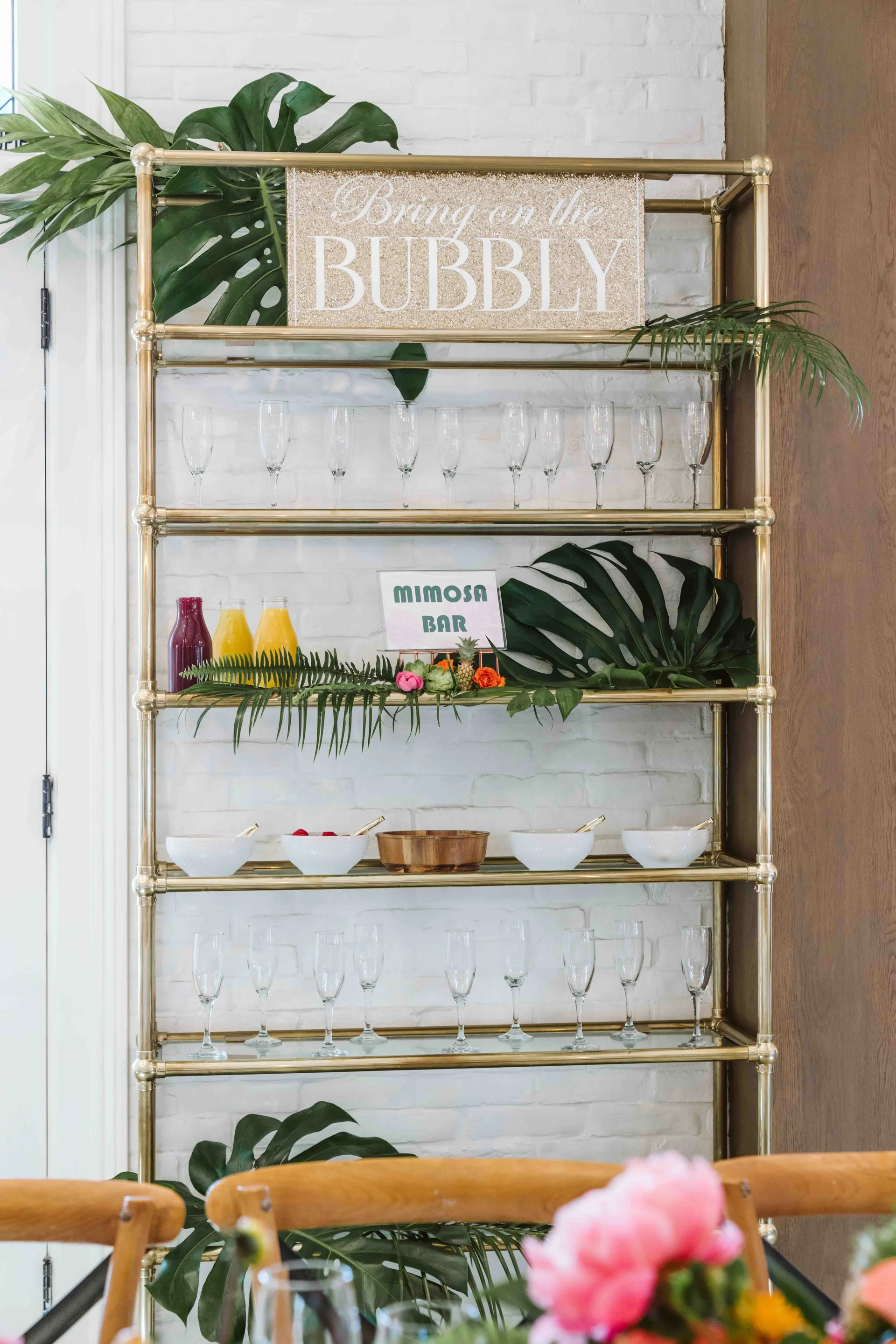 Café shelves decorated with flowers and beverage bottles