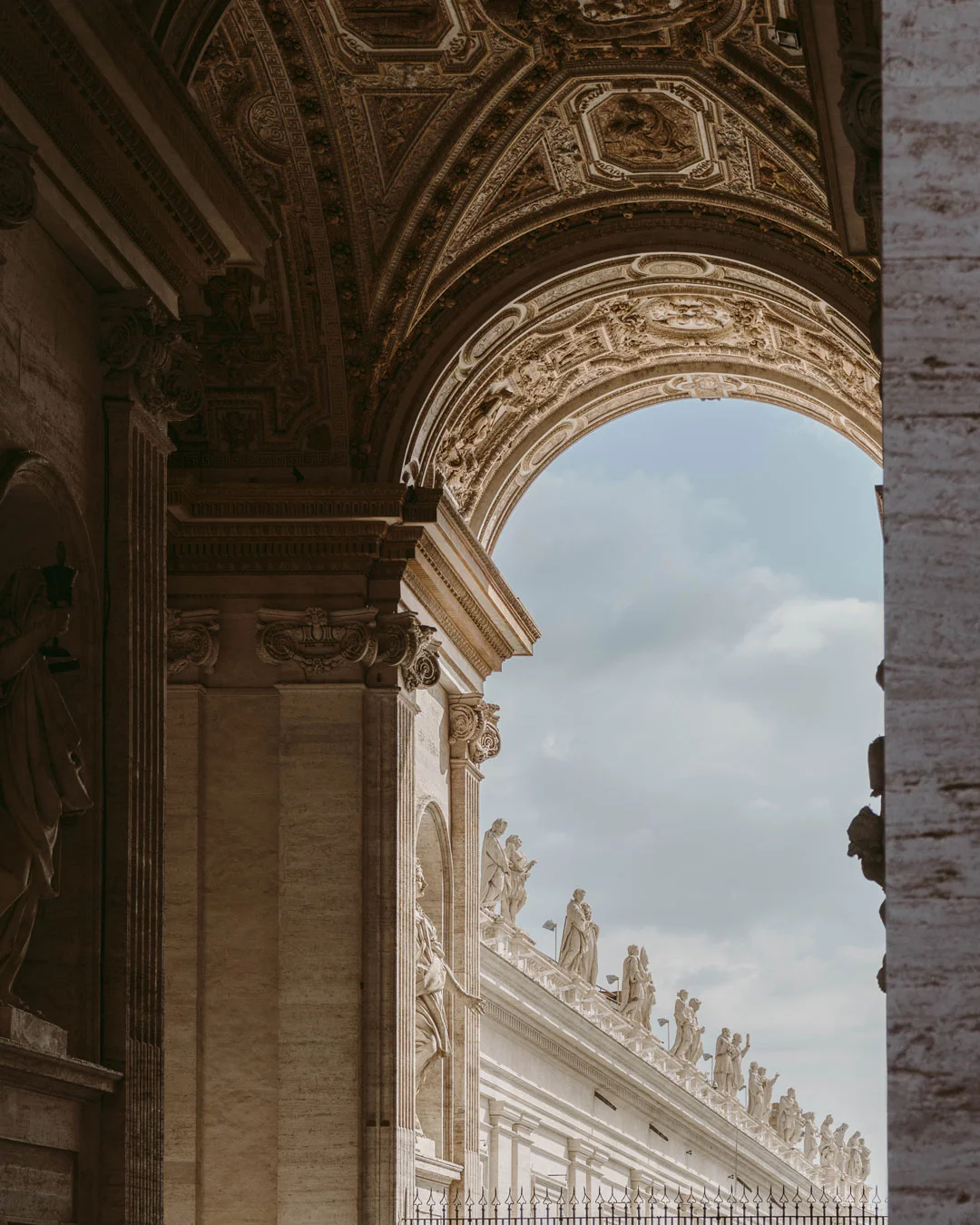 Ornate archway and statues at St. Peter’s Basilica