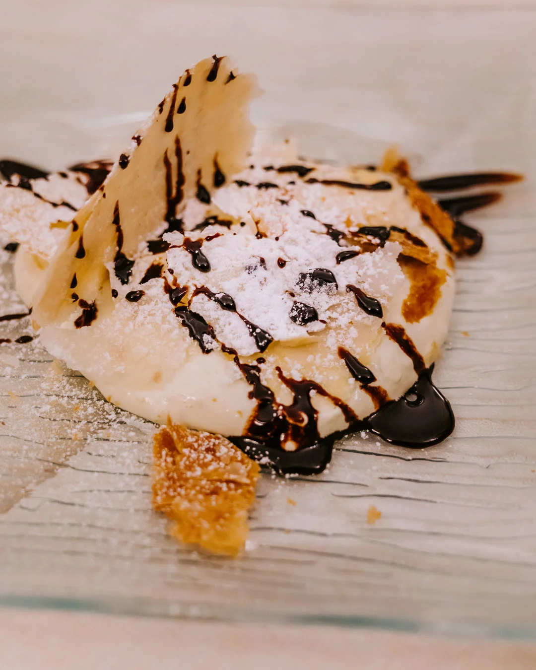 Ice cream dessert drizzled with chocolate sauce