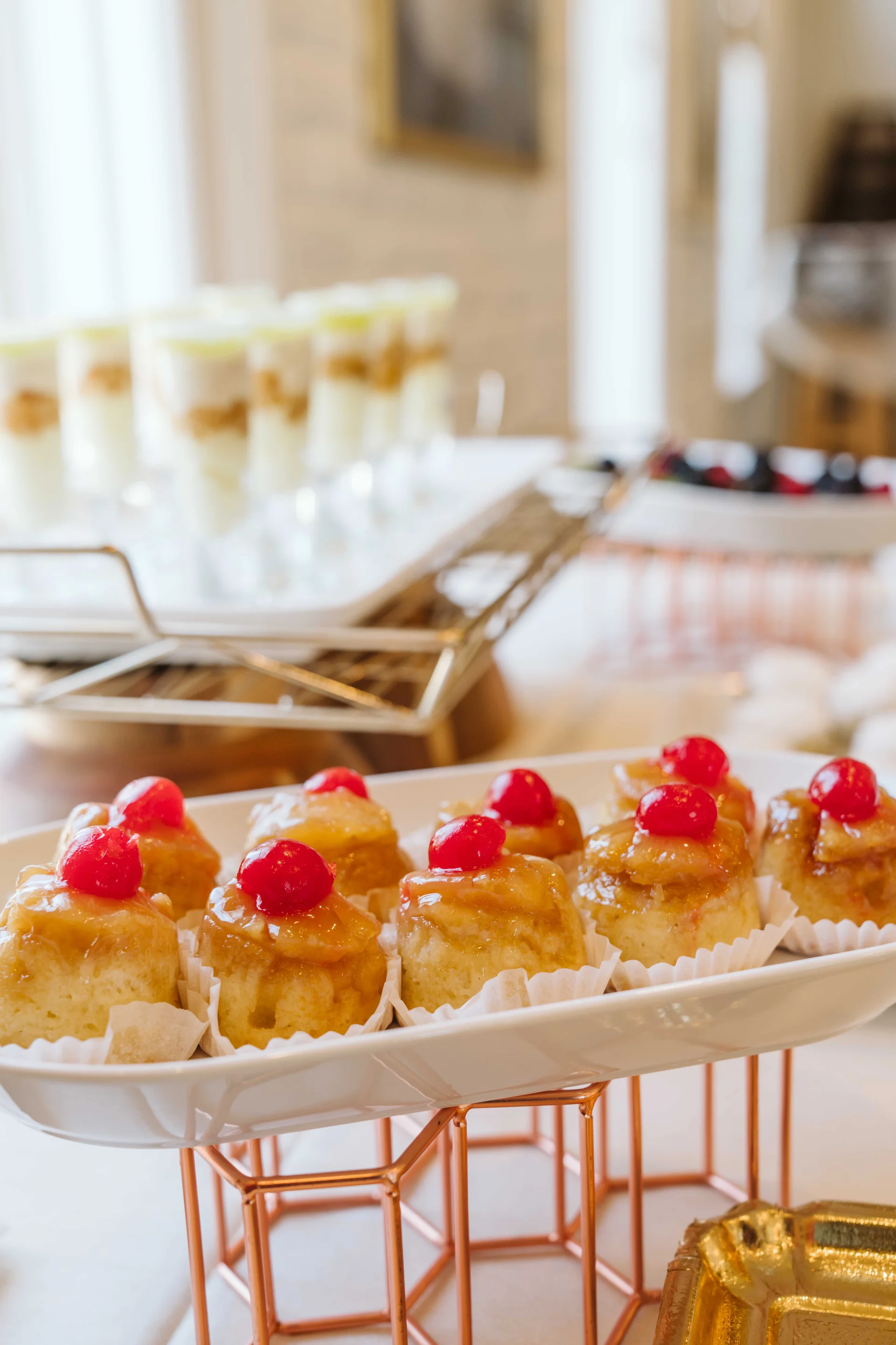 Pineapple upside-down cakes topped with cherries at the dessert station