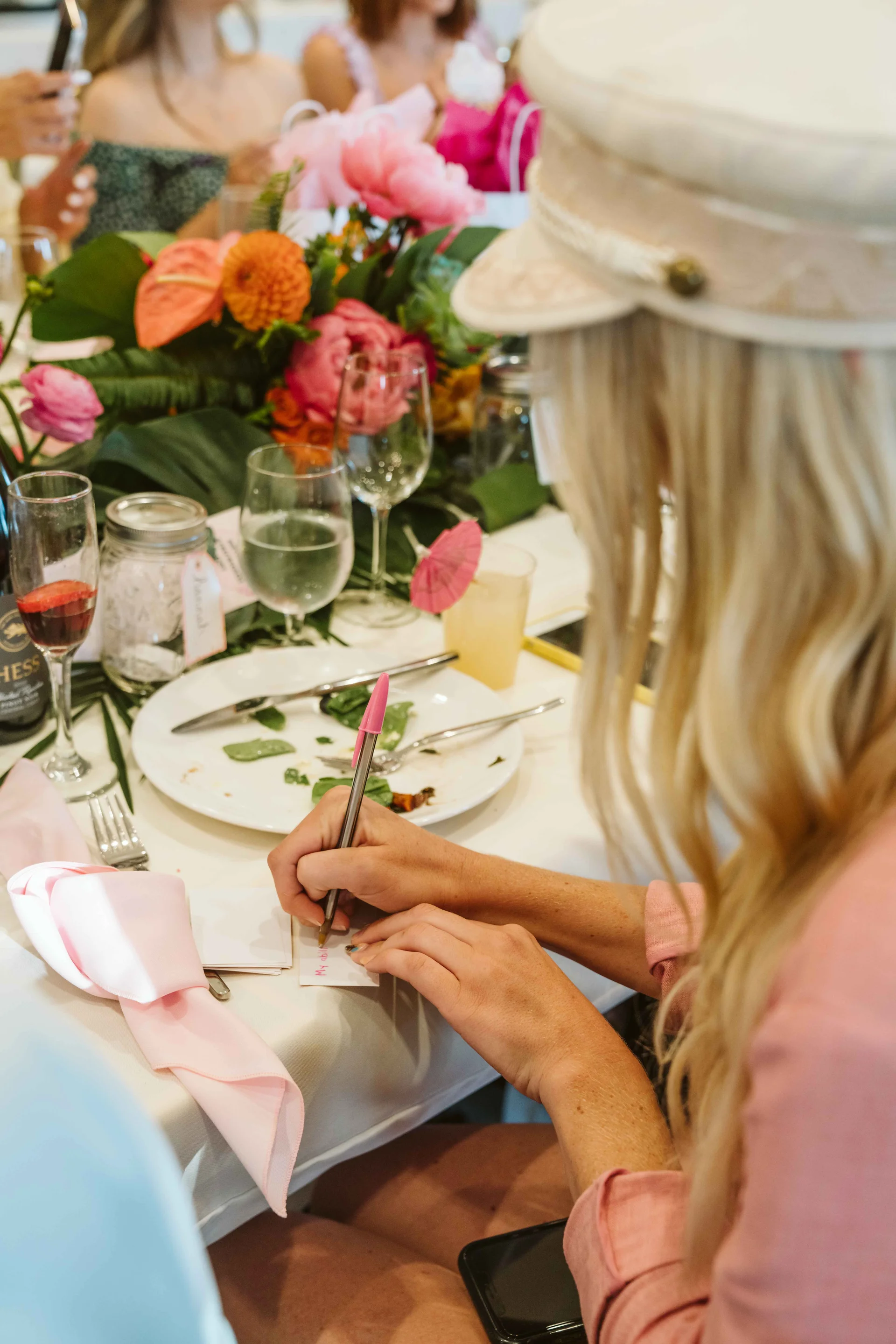 Guest writing an affirmation at the dinner table