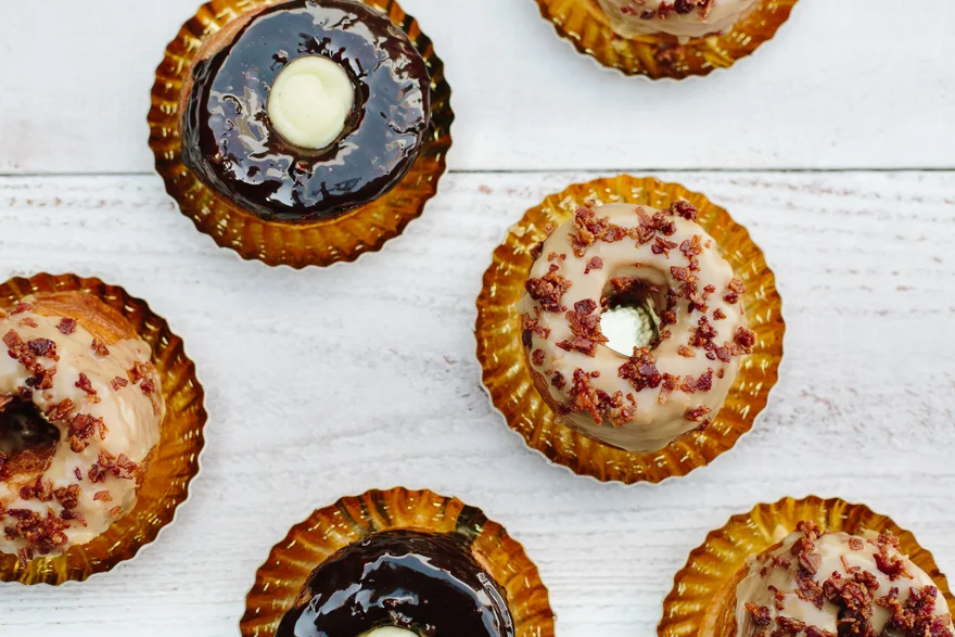 Assorted frosted pastries on a white table