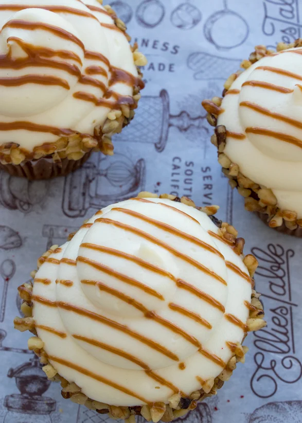 Carrot cake cupcakes with caramel-drizzled cream cheese frosting