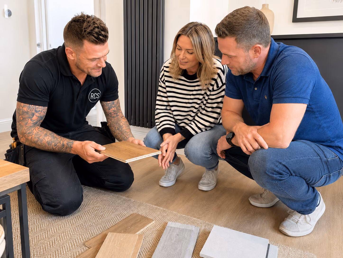 Rose Construction Sussex tradesman showing laminate flooring samples to homeowners during a home consultation in Eastbourne.