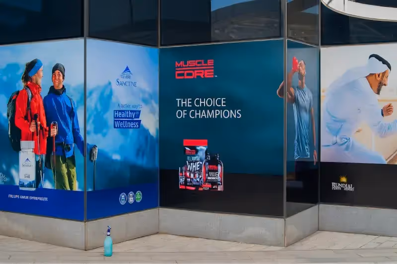 Printed vinyl window graphics for Al Reem Island pharmacy location providing storefront promotional displays and interior privacy with brand visibility.