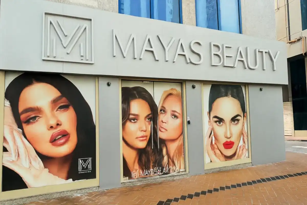 Corner window graphics paired with frontlit 3D acrylic signage creating cohesive storefront branding for beauty salon street presence.