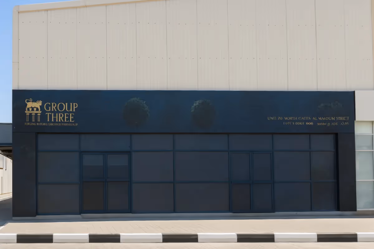 Group Three Interiors perforated one-way vision vinyl film with storefront signage overlay featuring cut-out painted acrylic lettering