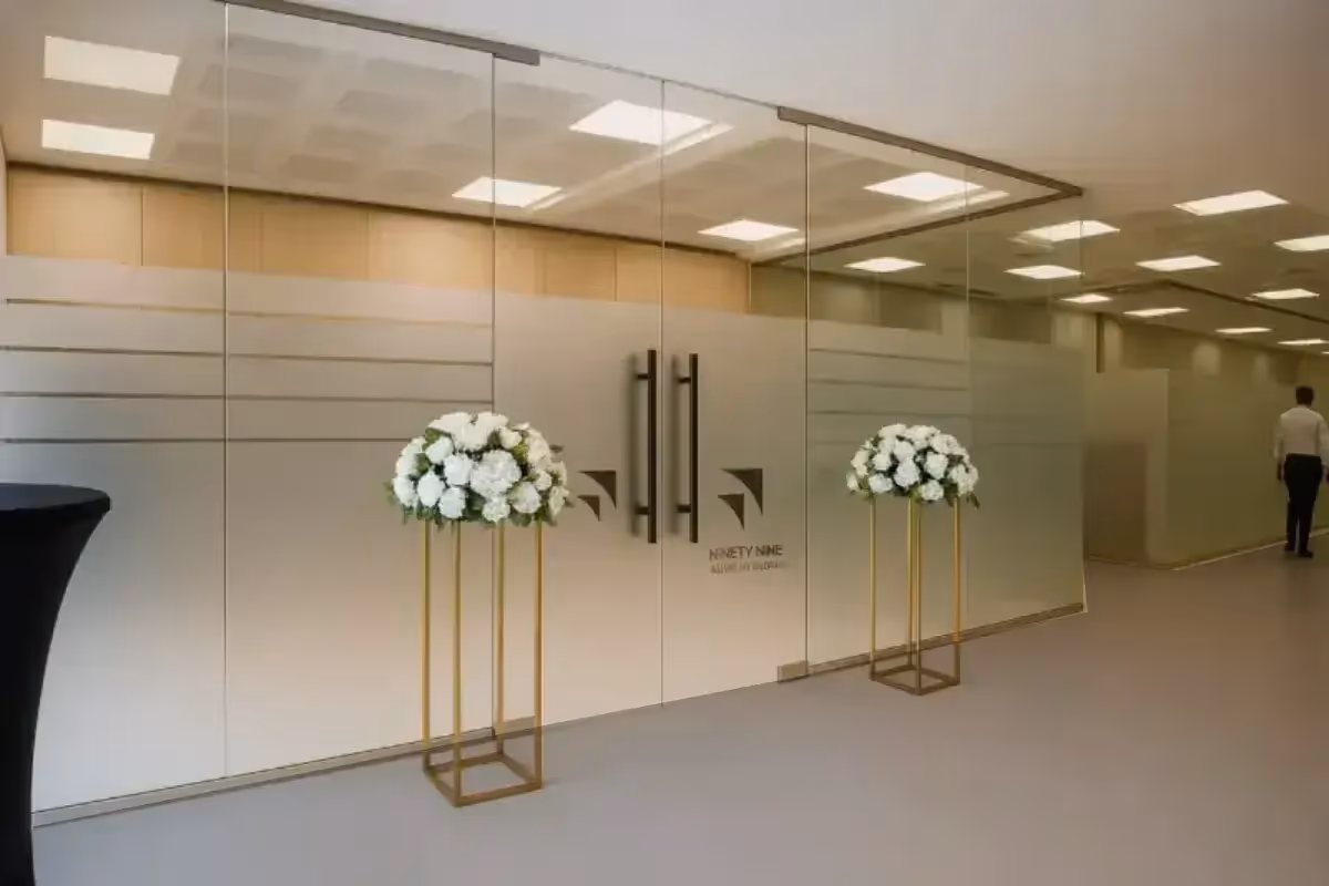 Global Beam Telecom reverse-cut frosted glass film with logo and striped patterns across office window and partition system.