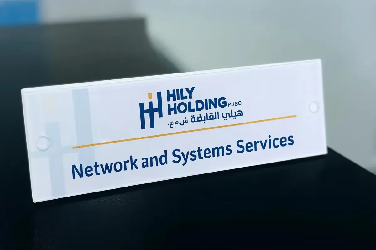 Reverse-printed acrylic door signs with mirror-finish hardware delivering cohesive wayfinding system for corporate office interiors.