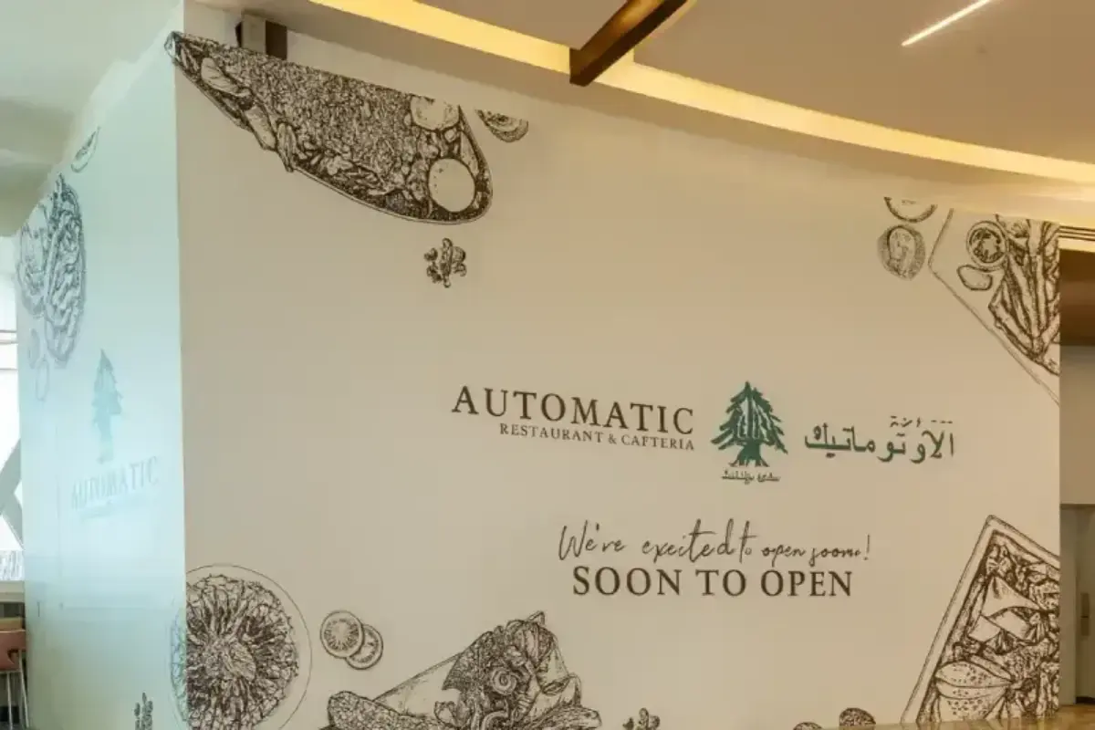 Automatic Restaurant temporary barrier hoarding branding at Marina Mall food court with custom-designed printed vinyl construction graphics.