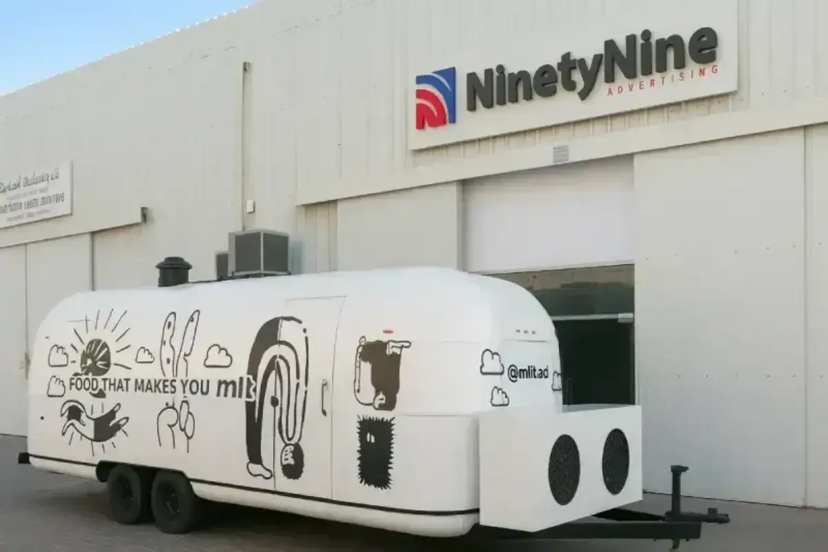 Complete food truck transformation from black to white base with custom brand identity patterns for mobile dining visibility.