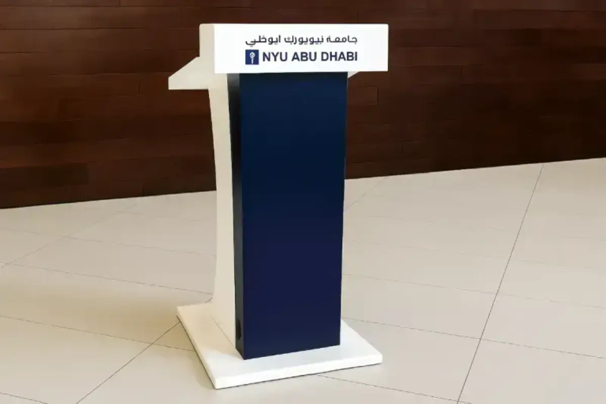Custom speaker podium with university branding delivering professional presentation platform for academic conferences and events.