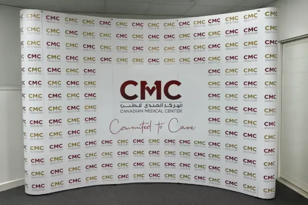 Curved pop-up display stand with logo pattern graphics delivering portable exhibition presence for medical and healthcare events.