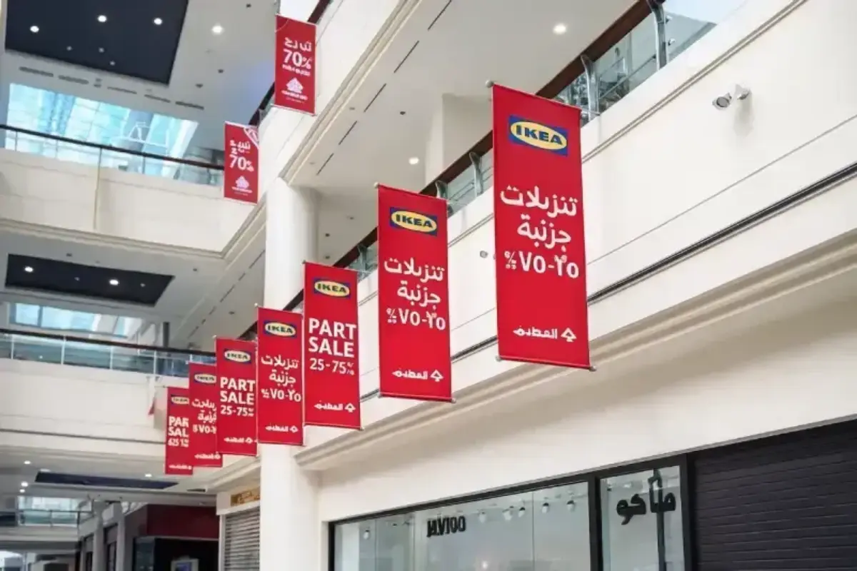 Double-sided hanging fabric banners suspended across mall atrium delivering promotional campaign visibility from multiple sightlines.