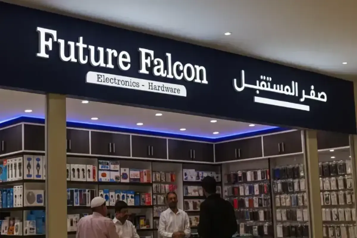 Illuminated dimensional signage fabricated for electronics retail storefront, featuring molded acrylic letterforms on colored backing panel with professional after-hours mall installation.