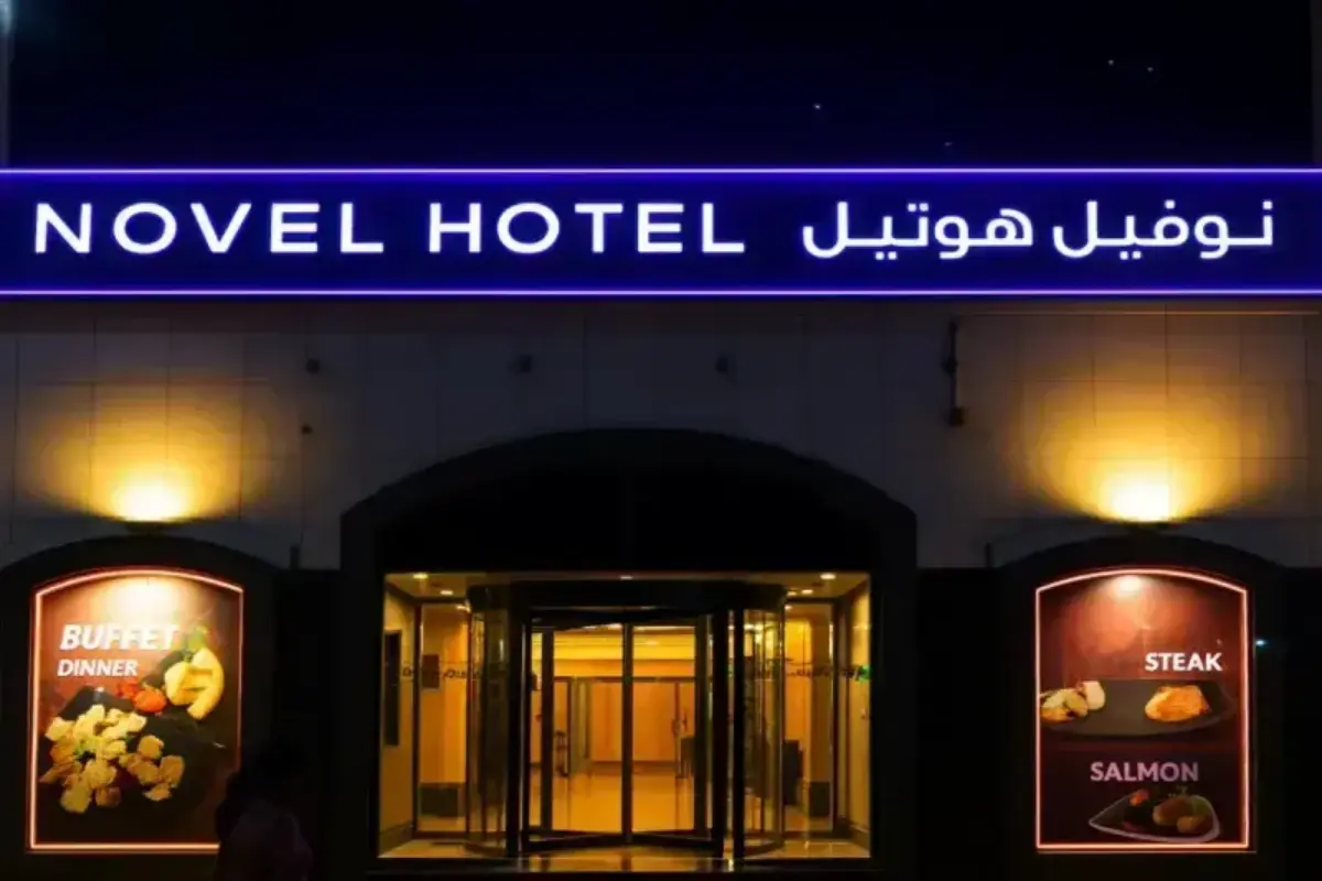 Hotel entrance identification system fabricated with frontlit dimensional lettering and decorative perimeter illumination, establishing prominent street-level brand presence for hospitality property.