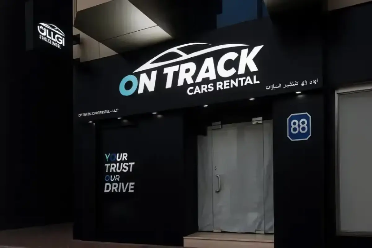 Complete storefront solution including main signage, matching pillar branding, and blade sign for car rental facility creating comprehensive visual identity.